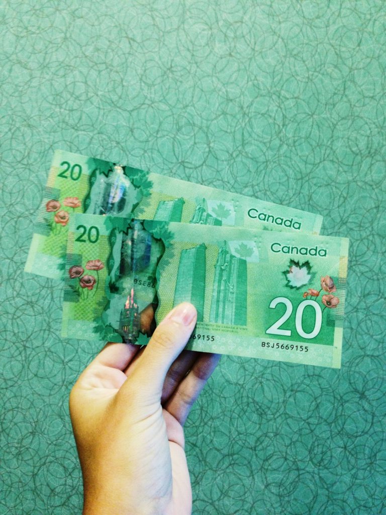 person-holding-two-20-canadian-dollar-banknotes-p22afmgmuuc